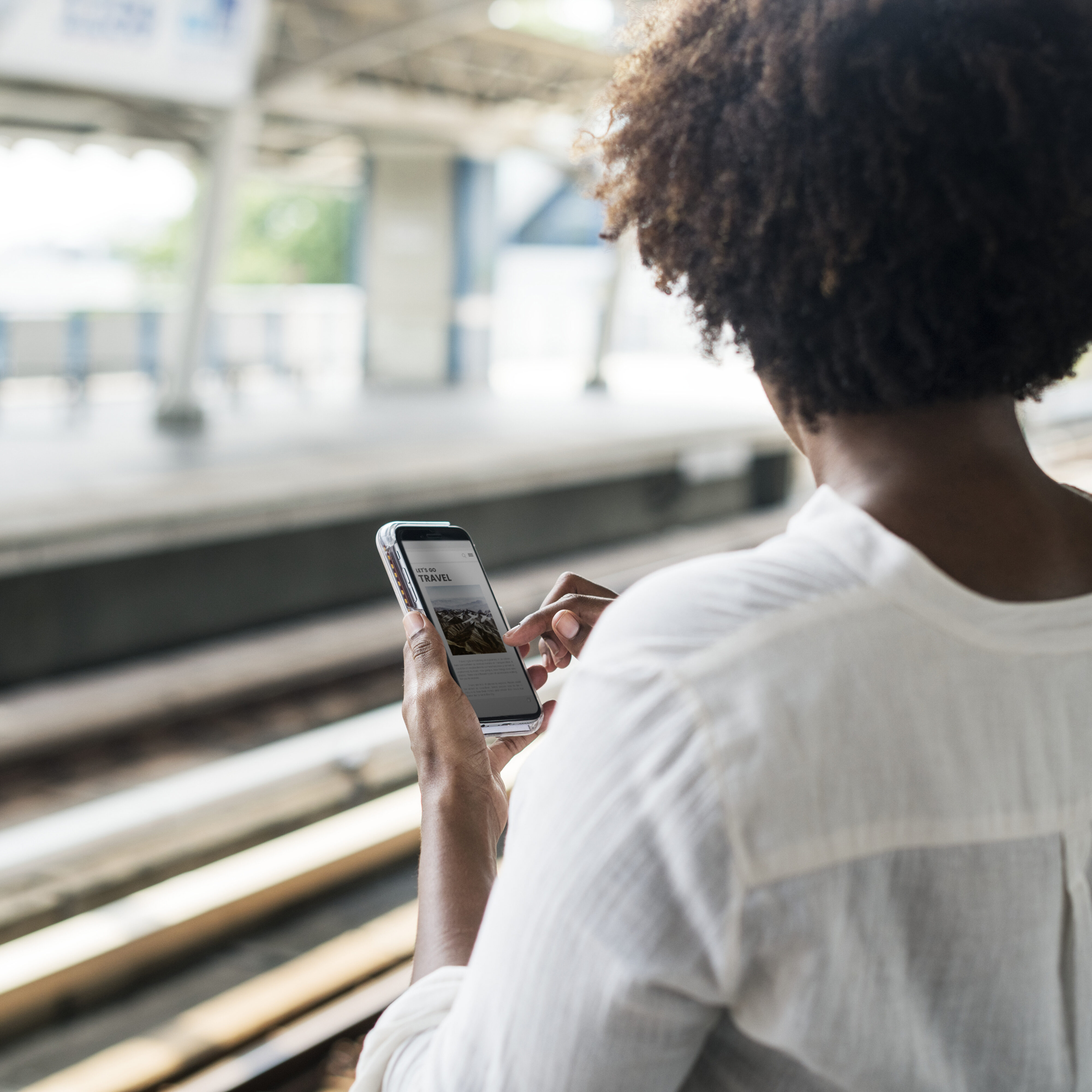 Woman waiting and playing on her phone